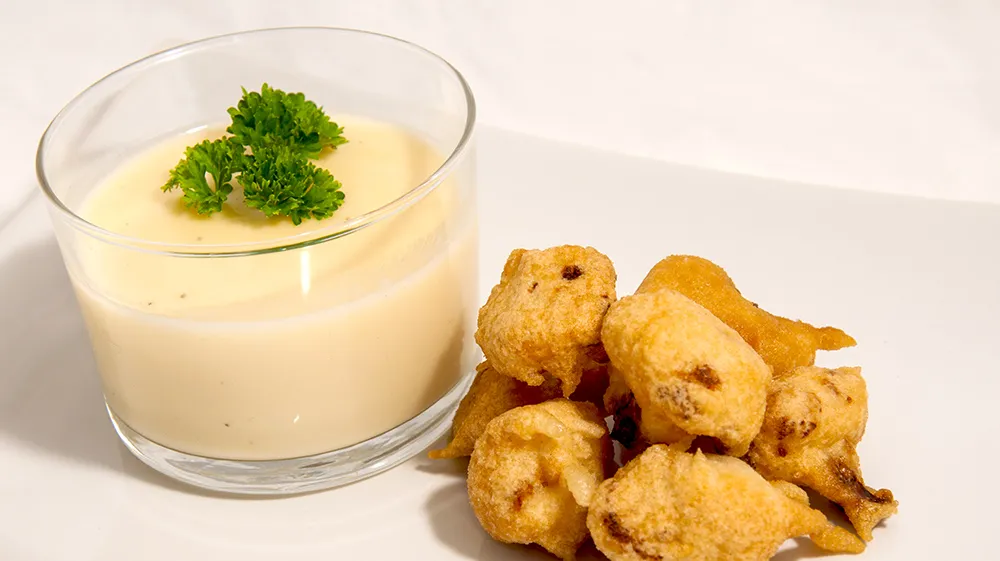 Deep-fried cauliflower with cheese sauce.